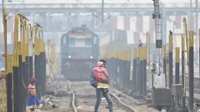 For Representation: A group of people walk across the railway track on a cold, foggy morning, in Lucknow. (PTI) For Representation: A group of people walk across the railway track on a cold, foggy morning, in Lucknow. (PTI)