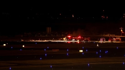 Japan plane fire: Firefighters work on remnants of a Coast Guard aircraft at Haneda International Airport, in Tokyo, Japan. (REUTERS)