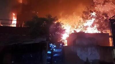 Smoke and flame billows from the shoe factory that caught fire, at Mangolpuri, in New Delhi on Saturday. (ANI Photo) (ANI) Smoke and flame billows from the shoe factory that caught fire, at Mangolpuri, in New Delhi on Saturday. (ANI Photo) (ANI)