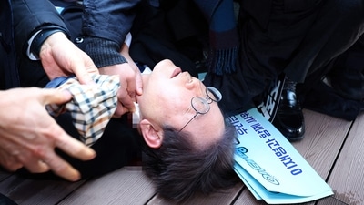 South Korean opposition party leader Lee Jae-myung is attended to after being attacked in Busan on January 2. (AFP) South Korean opposition party leader Lee Jae-myung is attended to after being attacked in Busan on January 2. (AFP)