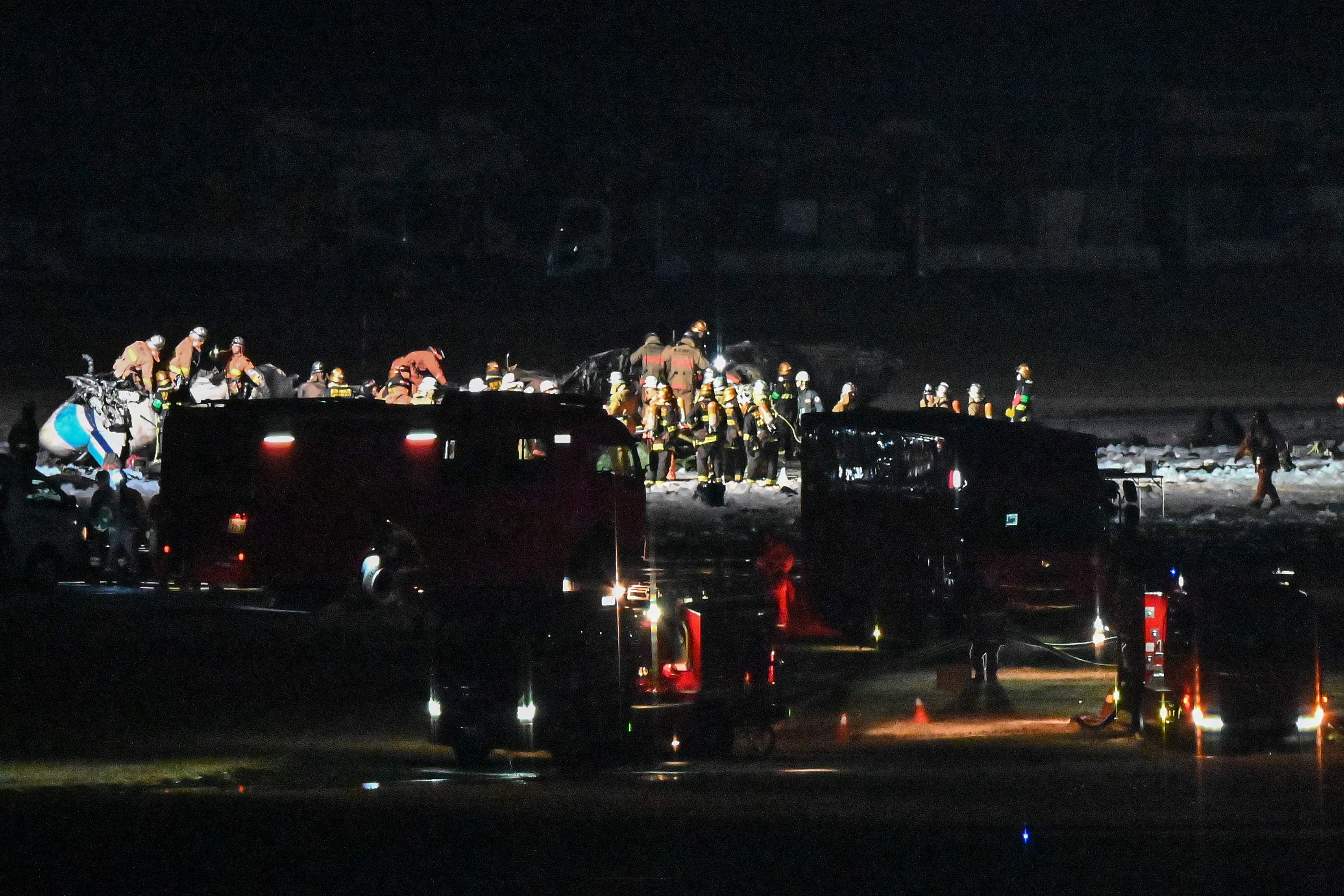 Rescue crews work at the site where a Japan coast guard aircraft collided with a Japan Airlines (JAL) passenger plane on the tarmac at Tokyo International Airport at Haneda. (AFP) Rescue crews work at the site where a Japan coast guard aircraft collided with a Japan Airlines (JAL) passenger plane on the tarmac at Tokyo International Airport at Haneda. (AFP)