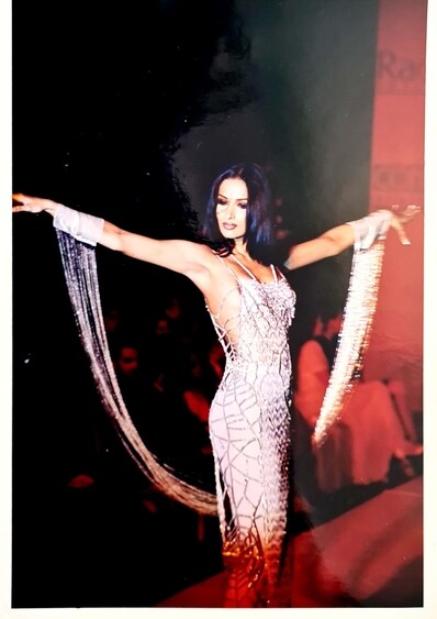 Malaika in silver long dress with a cobweb-like pattern made in cut dana and crystal by Rina Dhaka. Malaika in silver long dress with a cobweb-like pattern made in cut dana and crystal by Rina Dhaka.