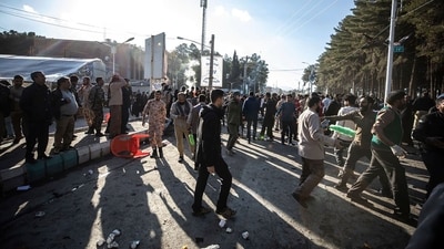 People look on after an explosion in Kerman, Iran (AP) People look on after an explosion in Kerman, Iran (AP)