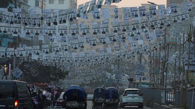 Bangladesh Elections 2024: Election campaign posters of Awami League hang on a road as traffic moves past ahead of the general election, in Dhaka. (Reuters)