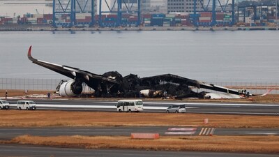 Officials investigate a burnt Japan Airlines (JAL) Airbus A350 plane after a collision with a Japan Coast Guard aircraft at Haneda International Airport in Tokyo (REUTERS)
