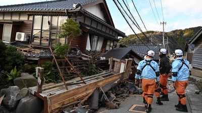 Firefighters inspect collapsed wooden houses in Wajima, Ishikawa prefecture on January 2, 2024. (AFP) Firefighters inspect collapsed wooden houses in Wajima, Ishikawa prefecture on January 2, 2024. (AFP)