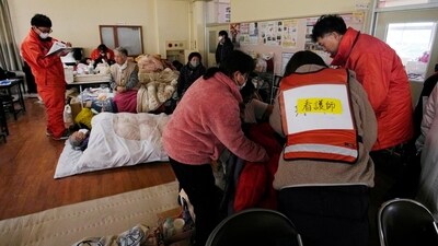 Medical staffers attend evacuees at a temporary evacuation center in Suzu in the Noto peninsula facing the Sea of Japan, northwest of Tokyo on Wednesday following Monday's deadly earthquake. (AP) Medical staffers attend evacuees at a temporary evacuation center in Suzu in the Noto peninsula facing the Sea of Japan, northwest of Tokyo on Wednesday following Monday's deadly earthquake. (AP)