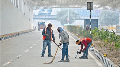 PWD workers give finishing touches to the underpass, ahead of its opening next week. (Raj K Raj/HT Photo)
