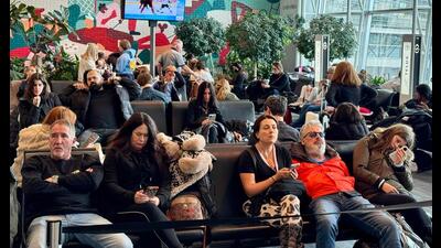 Passengers wait for their flights at Montreal-Pierre Elliott Trudeau International Airport, in Montreal, Canada, on Monday. (AFP)