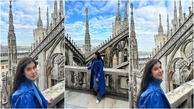 Shanaya captioned one of the posts, "Ciao Milano," and the second, "One cappuccino please." These photos show her posing in front of a cathedral and marvelling at the structure. She wore an all-blue attire for the outing. she chose a ribbed turtleneck sweater in a relaxed fitting, acid-washed denim jeans with quirky design elements, and a faux leather jacket. A chained over-the-body bag, chunky sneakers, centre-parted open locks, and a no-makeup look rounded it off. (Instagram) Shanaya captioned one of the posts, "Ciao Milano," and the second, "One cappuccino please." These photos show her posing in front of a cathedral and marvelling at the structure. She wore an all-blue attire for the outing. she chose a ribbed turtleneck sweater in a relaxed fitting, acid-washed denim jeans with quirky design elements, and a faux leather jacket. A chained over-the-body bag, chunky sneakers, centre-parted open locks, and a no-makeup look rounded it off. (Instagram)