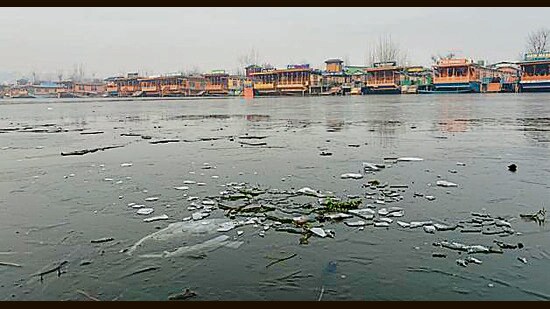 A layer of ice is formed over the surface of the Dal Lake during a cold morning in Srinagar on Wednesday. (ANI)
