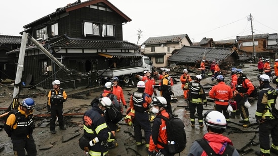 Rescue workers and canine units urgently sifted through rubble Wednesday ahead of predicted freezing cold and heavy rain in what the prime minister called a race against time after powerful earthquakes in western Japan killed multiple people.&nbsp;(AP)