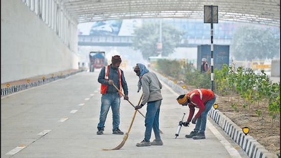 PWD workers give finishing touches to the underpass, ahead of its opening next week. (Raj K Raj/HT Photo)