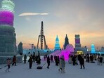 Visitors walk past ice sculptures at the Harbin Ice and Snow Festival in Harbin, Heilongjiang province, China 