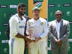 India's Jasprit Bumrah (L) and South Africa's Dean Elgar (C) hold the trophy for players of the series at Newlands stadium in Cape Town.