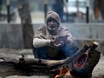 A man sits around a bonfire on a cold winter morning. (HT Photo) A man sits around a bonfire on a cold winter morning. (HT Photo)