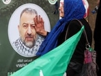 A woman touches a picture of deputy head of Hamas, Saleh al-Arouri, who was killed by what Lebanese and Palestinian security sources say was a drone strike by Israel, as mourners gather during his funeral in Beirut, Lebanon January 4, 2024. Israel has neither confirmed nor denied that it killed Arouri in the attack. REUTERS/Mohamed Azakir