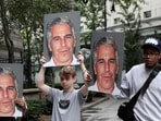 (File) Demonstrators hold signs aloft protesting against Jeffrey Epstein (File) Demonstrators hold signs aloft protesting against Jeffrey Epstein