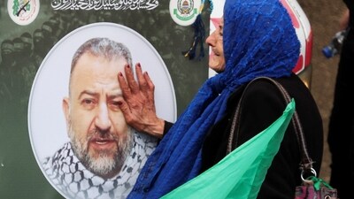 A woman touches a picture of deputy head of Hamas, Saleh al-Arouri, who was killed by what Lebanese and Palestinian security sources say was a drone strike by Israel, as mourners gather during his funeral in Beirut, Lebanon January 4, 2024. Israel has neither confirmed nor denied that it killed Arouri in the attack. REUTERS/Mohamed Azakir (REUTERS)