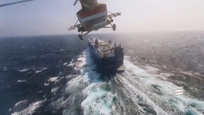 FILE PHOTO: Houthi military helicopter flies over the Galaxy Leader cargo ship in the Red Sea in this photo released November 20, 2023. Houthi Military Media/Handout via REUTERS//File Photo (via REUTERS)
