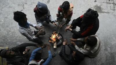 People warm themselves around a bonfire on a foggy winter morning in New Delhi on Thursday. (Sanjeev Verma/ HT Photo) People warm themselves around a bonfire on a foggy winter morning in New Delhi on Thursday. (Sanjeev Verma/ HT Photo)