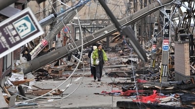 People walk past fallen utility poles and damaged buildings in the city of Wajima, Ishikawa prefecture on January 4, 2024, after a major 7.5 magnitude earthquake struck the Noto region in Ishikawa prefecture on New Year's Day. More than 50 people were reported missing on January 4 as Japanese rescuers battled to reach hundreds still cut off from help three days after a devastating earthquake left at least 78 dead. (Photo by Kazuhiro NOGI / AFP) People walk past fallen utility poles and damaged buildings in the city of Wajima, Ishikawa prefecture on January 4, 2024, after a major 7.5 magnitude earthquake struck the Noto region in Ishikawa prefecture on New Year's Day. More than 50 people were reported missing on January 4 as Japanese rescuers battled to reach hundreds still cut off from help three days after a devastating earthquake left at least 78 dead. (Photo by Kazuhiro NOGI / AFP)