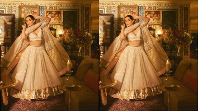 Sonam's all-white look featured a plunging v-neck blouse embellished with intricate gold lace along the borders. She paired it with a matching flared skirt with a golden shimmering hemline. She completed her look with an off-white net duppata. (Instagram/@sonamkapoor) Sonam's all-white look featured a plunging v-neck blouse embellished with intricate gold lace along the borders. She paired it with a matching flared skirt with a golden shimmering hemline. She completed her look with an off-white net duppata. (Instagram/@sonamkapoor)