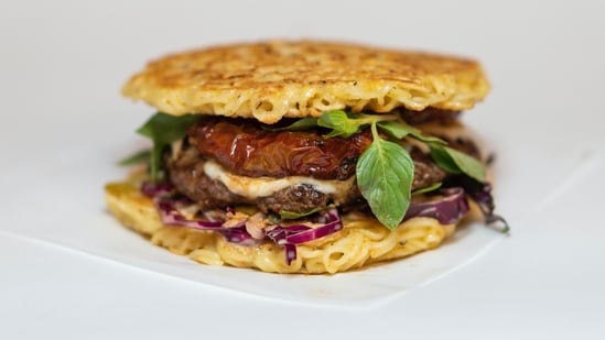 The Ramen Burger from New York: The Ramen Burger is a unique food item that gained popularity in New York City. It features a beef patty sandwiched between two buns made from compressed ramen noodles, creating a fusion of Japanese and American flavours.&nbsp;&nbsp;(Unsplash)
