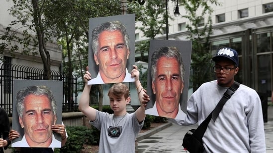 (File) Demonstrators hold signs aloft protesting against Jeffrey Epstein (Reuters)