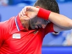 Serbia's Novak Djokovic reacts during his men's singles match against Australia's Alex de Minaur. Serbia's Novak Djokovic reacts during his men's singles match against Australia's Alex de Minaur.