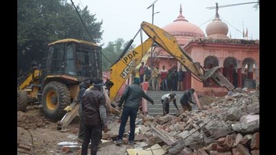 Illegal structures near Bhardwaj Park premises were demolished on Friday. (HT Photo)