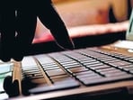 cyber crime hacker typing on laptop
