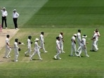 Australia's David Warner, second right, is hugged by teammate Marnus Labuschagne while Pakistan players arrive to congratulate Warner as he walks off the field after he lost his wicket on the fourth day of their cricket test match in Sydney, Saturday Australia's David Warner, second right, is hugged by teammate Marnus Labuschagne while Pakistan players arrive to congratulate Warner as he walks off the field after he lost his wicket on the fourth day of their cricket test match in Sydney, Saturday