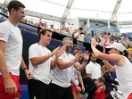 Poland's Iga Swiatek, right, celebrates with her teammates after defeating Caroline Garcia of France in their United Cup semifinal tennis match in Sydney, Australia, Saturday, Jan. 6
