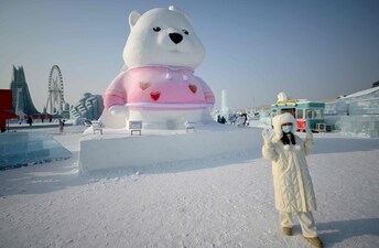 A visitor poses with a snow sculpture at the theme park in China’s northern Heilongjiang | Photos: AFP and Reuters