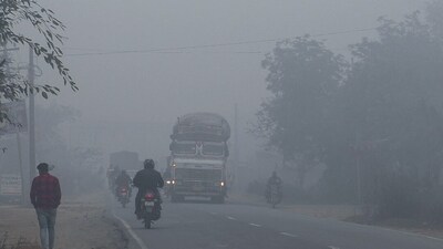 Commuters travel through dense fog amid cold winter waves, in Aligarh on Thursday. (ANI) Commuters travel through dense fog amid cold winter waves, in Aligarh on Thursday. (ANI)