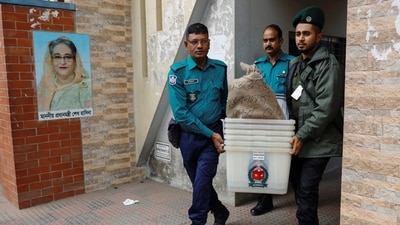 Officials carry ballot boxes for distribution to the voting centres as part of election preparation, a day ahead of the general election in Dhaka, Bangladesh. (REUTERS)