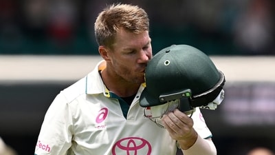 Australia's David Warner kisses the coat of arms on his helmet as he leaves the field in his last test match (via REUTERS)