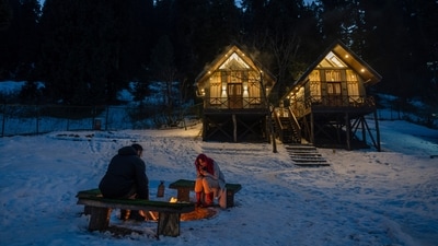 Tourists from Kenya sit by a bonfire outside a cottage in Drang village, northwest of Srinagar, Renowned for its breathtaking landscapes, Kashmir in winter transforms into a wonderland. Tourists fill its hotels to ski, sledge and trek the Himalayan landscape. (AP) Tourists from Kenya sit by a bonfire outside a cottage in Drang village, northwest of Srinagar, Renowned for its breathtaking landscapes, Kashmir in winter transforms into a wonderland. Tourists fill its hotels to ski, sledge and trek the Himalayan landscape. (AP)