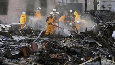 White smoke rises as firefighters work amid the wreckage from a fire at a burnt market in Wajima, Ishikawa prefecture, Japan Saturday, Jan. 6, 2024. A series of powerful quakes set off a large fire in the town of Wajima, as well as tsunamis and landslides in the region. (Kyodo News via AP) (AP) White smoke rises as firefighters work amid the wreckage from a fire at a burnt market in Wajima, Ishikawa prefecture, Japan Saturday, Jan. 6, 2024. A series of powerful quakes set off a large fire in the town of Wajima, as well as tsunamis and landslides in the region. (Kyodo News via AP) (AP)
