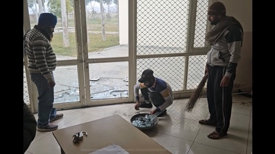 Staff clearing the broken shards of glass after the incident on Friday. (HT FIle)