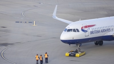 Ground staff near a passenger aircraft, operated by British Airways Plc, at Heathrow Airport Terminal 5, in London, UK. (Bloomberg) Ground staff near a passenger aircraft, operated by British Airways Plc, at Heathrow Airport Terminal 5, in London, UK. (Bloomberg)