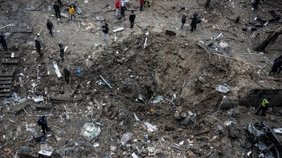 People stand next to a crater at a site of a Russian missile strike, amid Russia's attack on Ukraine. (Reuters/Representational image)