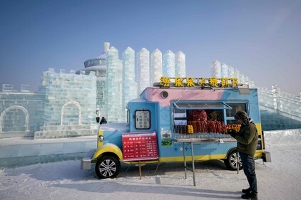 A man stands beside a food van