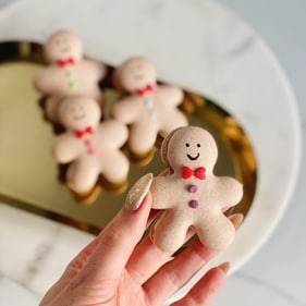 Gingerbreadmen shaped macaroons with a chocolate ganache filling (Instagram)