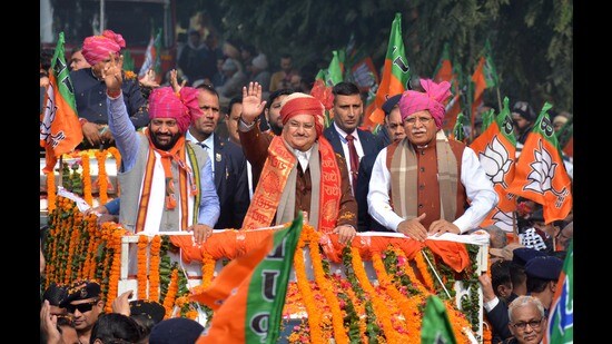 BJP president JP Nadda with Haryana chief minister Manohar Lal Khattar (right) and state party chief Nayab Saini (left) during a roadshow in Panchkula on Saturday. (Sant Arora/HT)