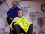 Former Brazilian player and coach Mario Jorge Lobo Zagallo poses for a picture next to a statue representing him during a ceremony in his tribute in Rio de Janeiro