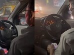 Uber driver watching videos while navigating through traffic in Mumbai. Uber driver watching videos while navigating through traffic in Mumbai.