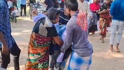 Parents of a girl student carry her who fainted during Gunotsav Programme at Ramkrishnanagar Vidyapith in Karimganj (HT Photo/Sourced) Parents of a girl student carry her who fainted during Gunotsav Programme at Ramkrishnanagar Vidyapith in Karimganj (HT Photo/Sourced)