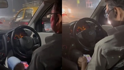 Uber driver watching videos while navigating through traffic in Mumbai. (X/@snakeyesV1)
